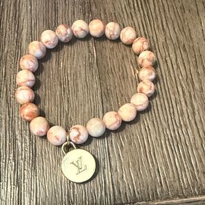Pink and cream stone stretchy bracelet with LV cream charm.